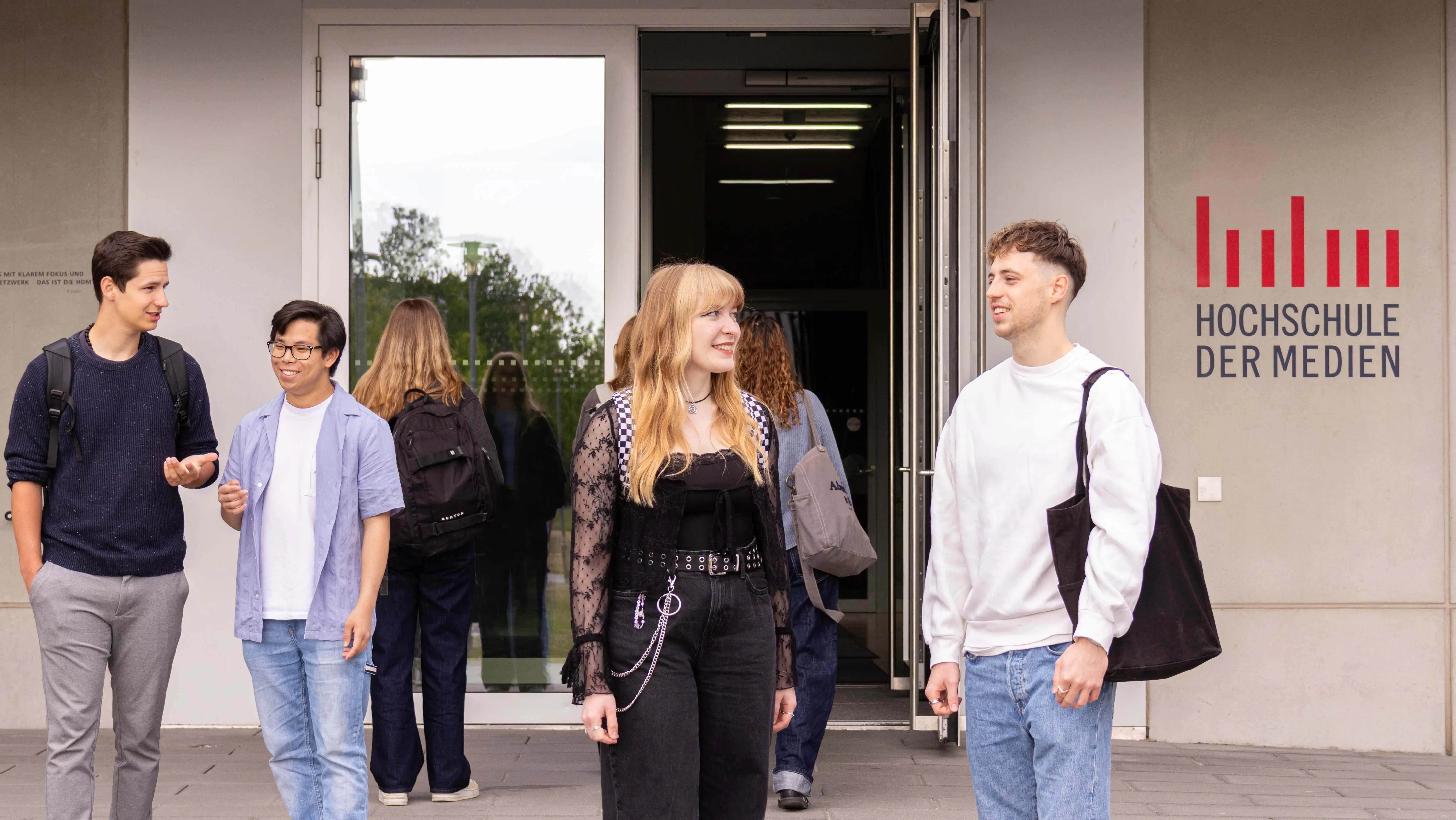 Studierende unterhalten sich vor dem sogenannten Würfel, einem Nebengebäude der Hochschule der Medien.